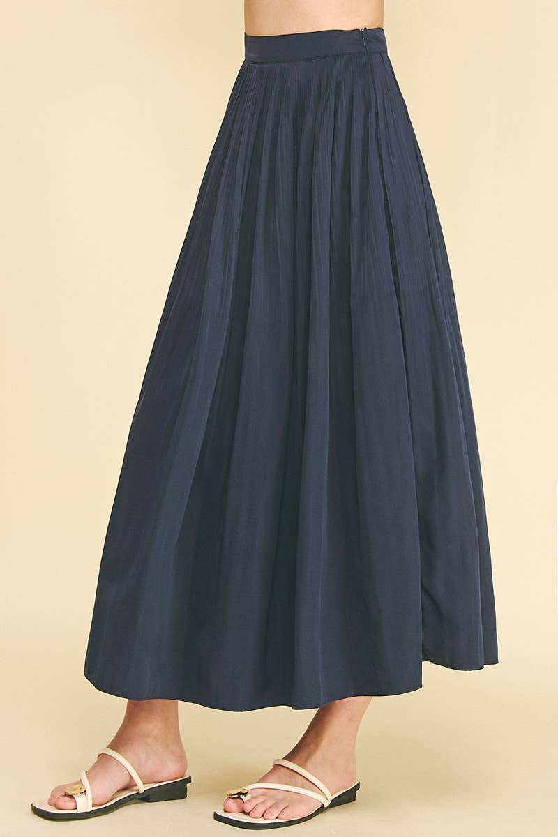 Bess Skirt in Deep Navy — movement shot of the A-line hem