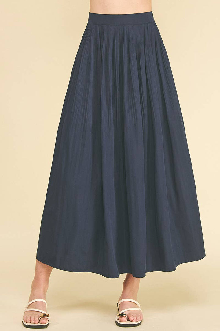 Bess Skirt in Deep Navy — front view showing pleat detail