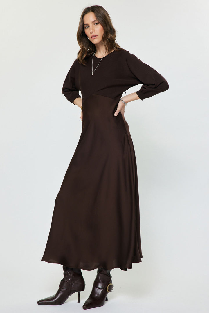 Verity Dress in Chocolate — side view of the flared satin midi skirt