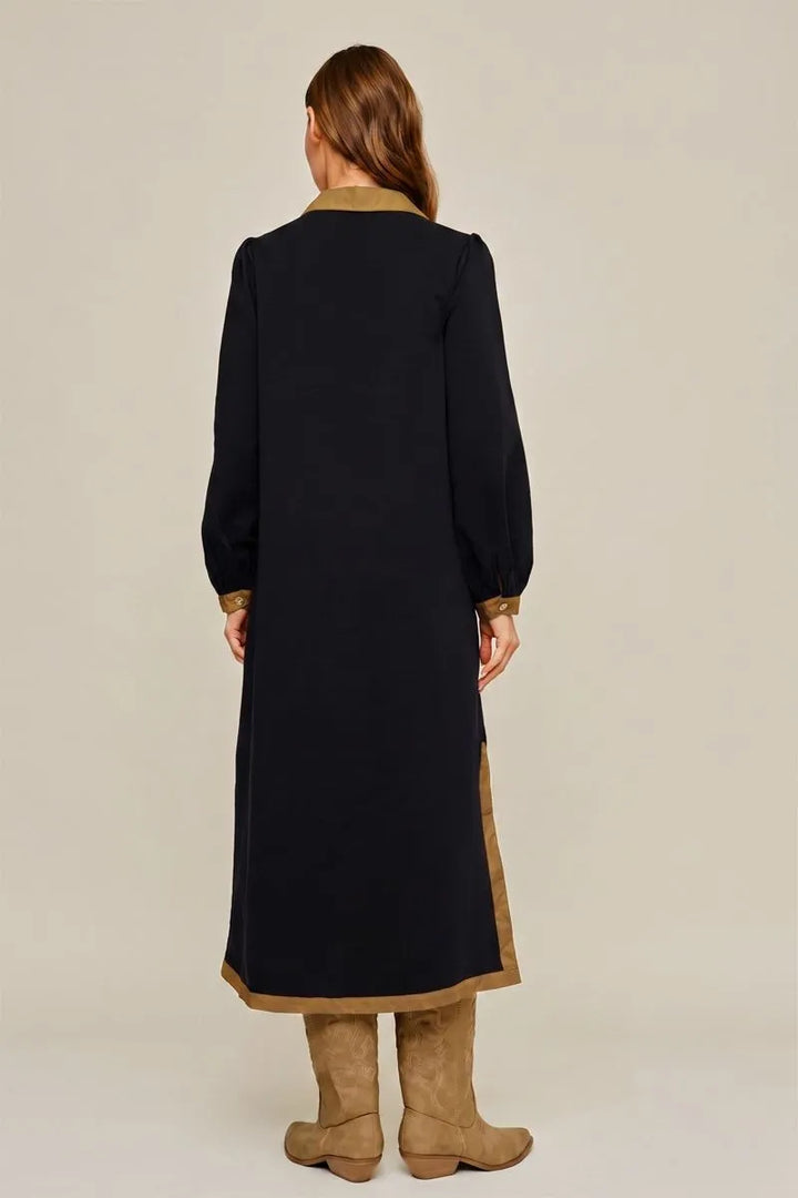 Vivie Dress in black — back view showing the hem border and side slit